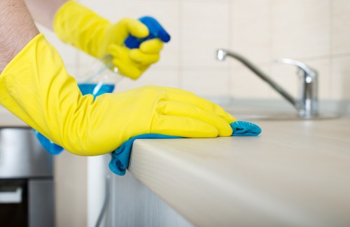Professional weekly cleaning tasks in a Notting Hill flat kitchen and living area