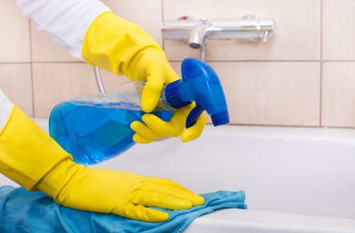 Cleaning professional starting a service with supplies near a property entrance