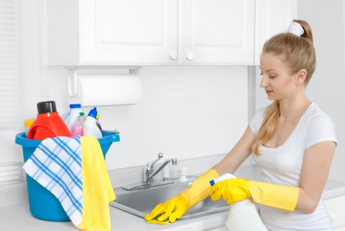 Cleaner wearing protective gloves while preparing safe cleaning supplies